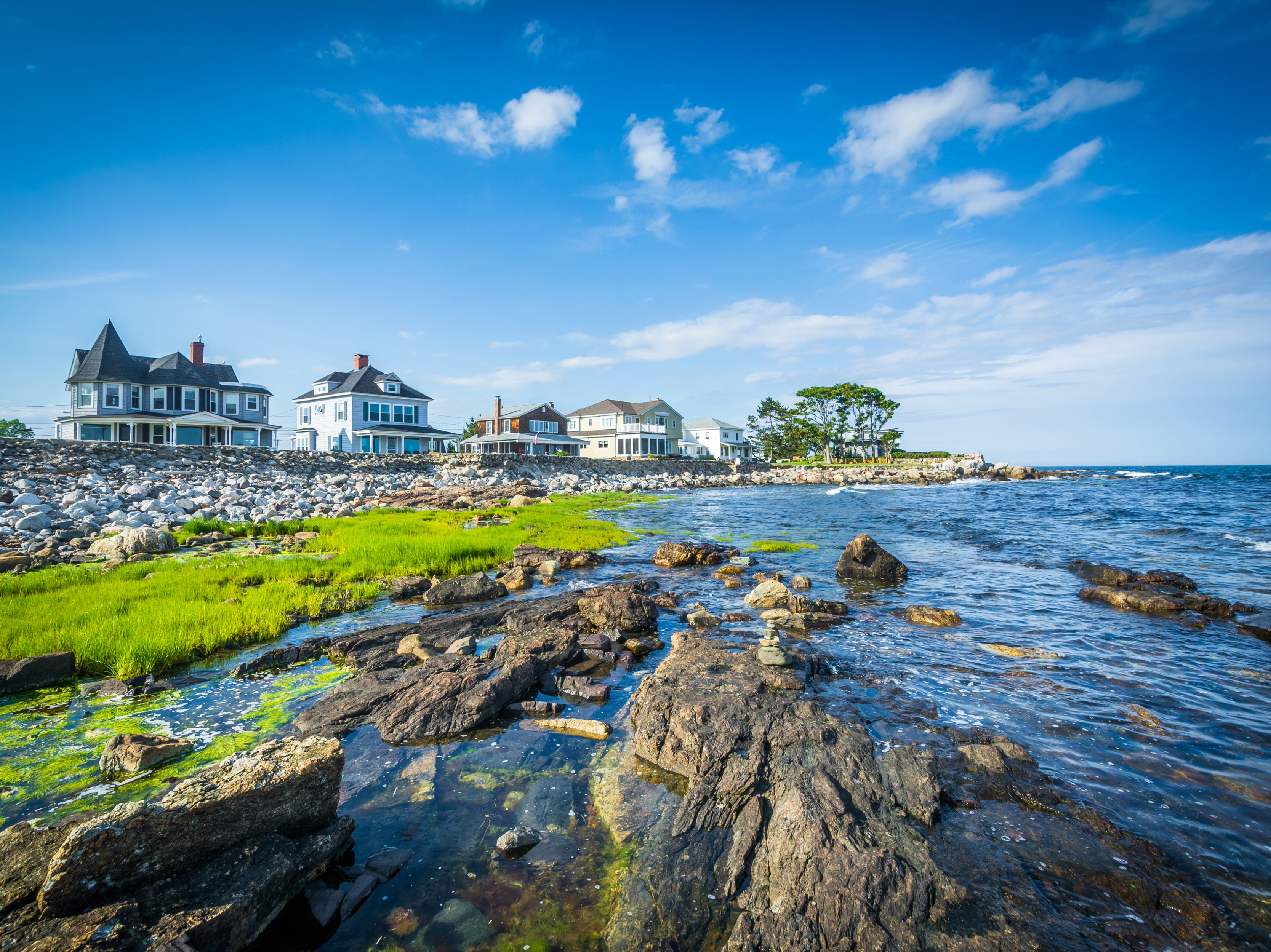 An aerial view of the coastline near Rye Beach highlights the beautiful seaside settings that surround luxury homes in New Hampshire, offering residents easy access to both pristine beaches and the Lakes Region.